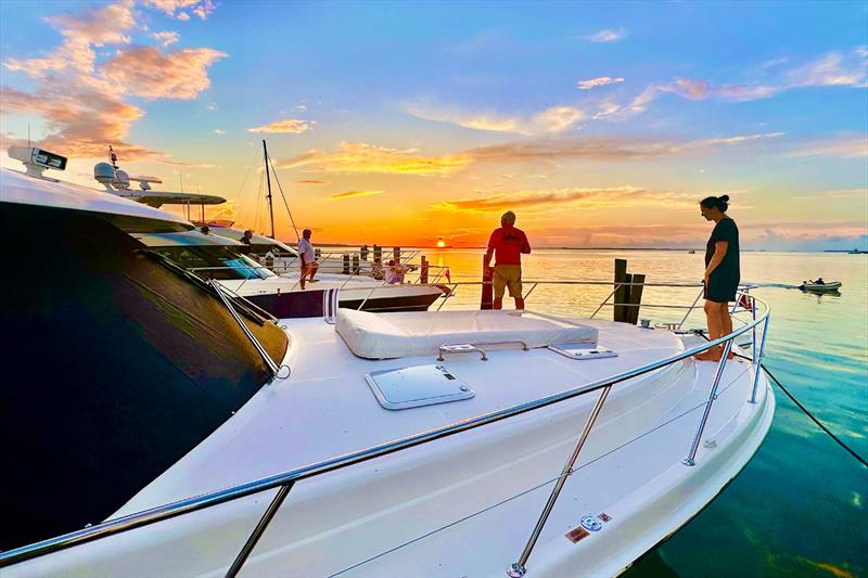 What a view! The sun sinks into the sea as Rendezvous to the Exumas guests gaze at the gorgeous orange sky photo copyright Riviera Australia taken at  and featuring the Power boat class