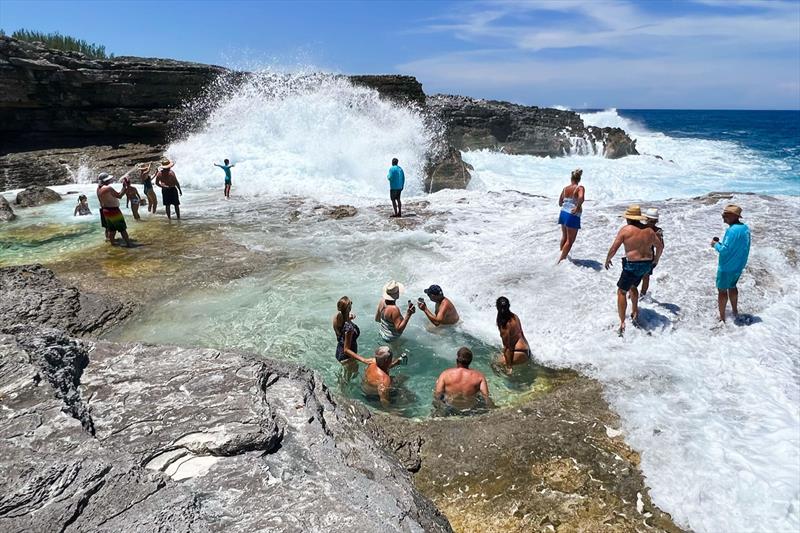 Warm waves crash over the rocks as Rendezvous guests enjoy the morning sun photo copyright Riviera Australia taken at  and featuring the Power boat class