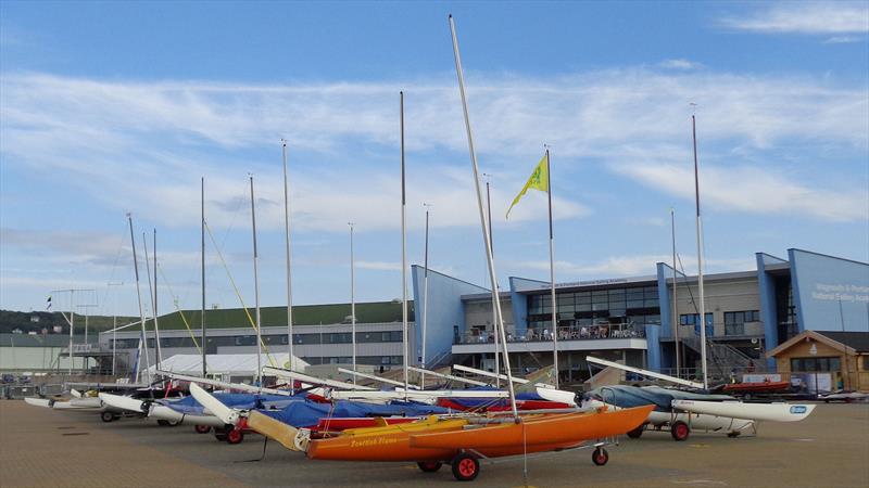 Challengers lined up at the iconic WPNSA building, ahead of the RYA Sailability Multiclass Regatta 2019 photo copyright Marion Edwards taken at Weymouth & Portland Sailing Academy and featuring the Challenger class