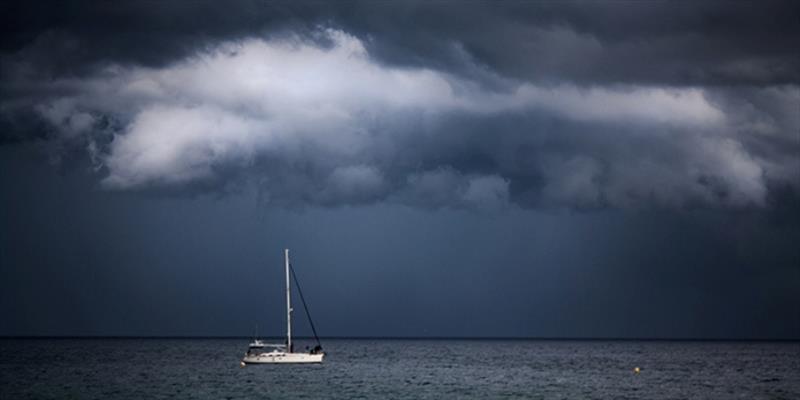A sailboat in stormy conditions. Don't let this happen to you: Check the marine weather forecast before you depart, and carry a weather radio while on the water photo copyright iStock taken at  and featuring the Cruising Yacht class