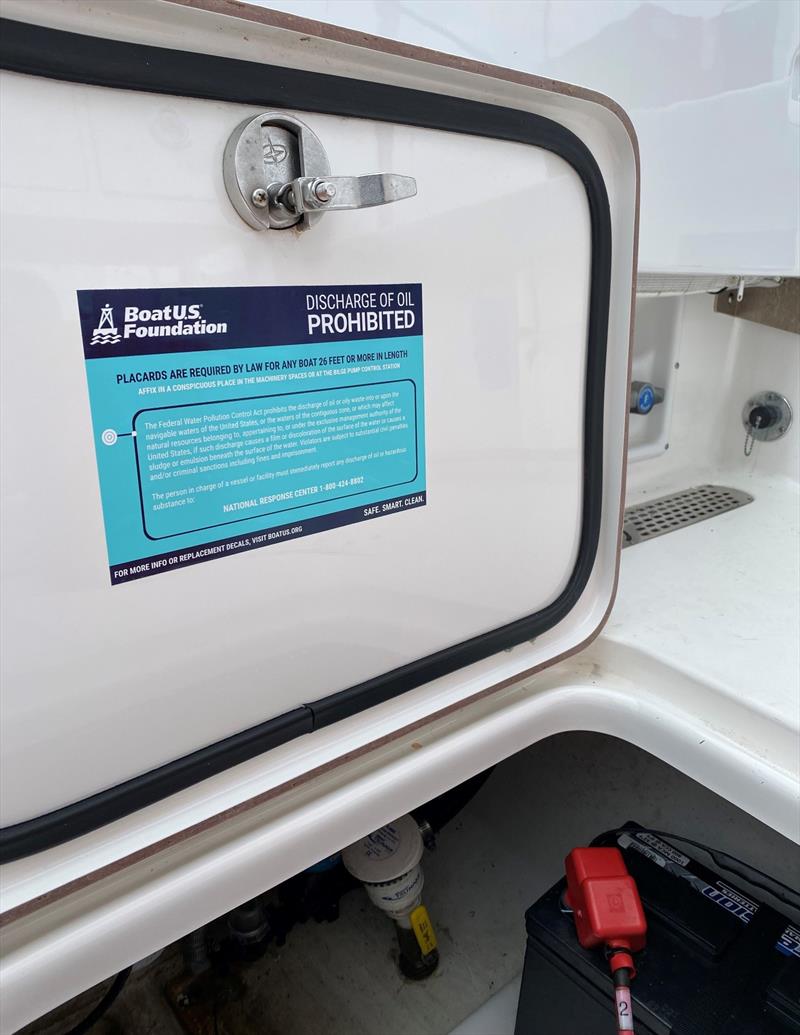 The BoatUS Foundation oil discharge placard decal on machinery spaces, such as a bilge access door, helps ensure proper handling of oil waste - photo © Scott Croft