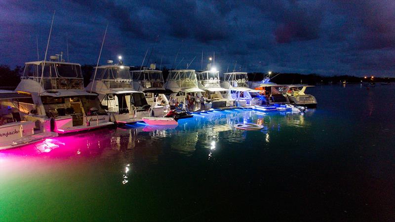 Underwater lights add to the festive atmosphere of the 26 Riviera motor yachts in the Gold Coast raft-up photo copyright Riviera taken at  and featuring the Power boat class