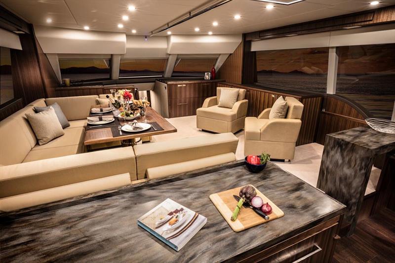 Luxurious saloon with a U-shaped leather lounge around the beautifully finished dining table photo copyright Riviera Australia taken at  and featuring the Power boat class