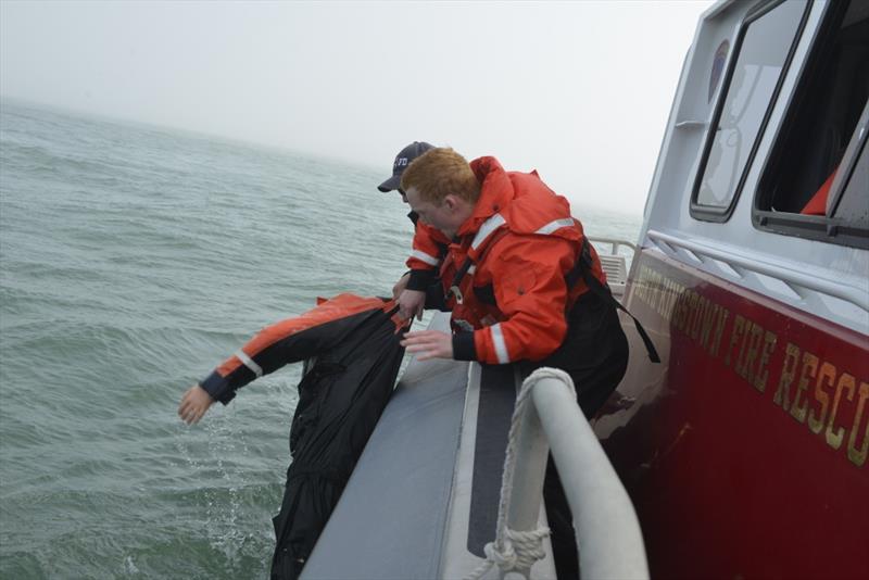 Seaman Josh Olsen assists a North Kingston fire fighter in rescuing the Coast Guard training dummy 'Oscar' from the sea off Point Judith, Rhode Island, Thursday, April 19, 2018 photo copyright Petty Officer 3rd Class Nicole J. Groll taken at  and featuring the Power boat class
