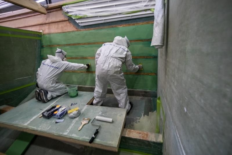 Hull side insulation being installed between battens - photo © Bayliss Boatworks