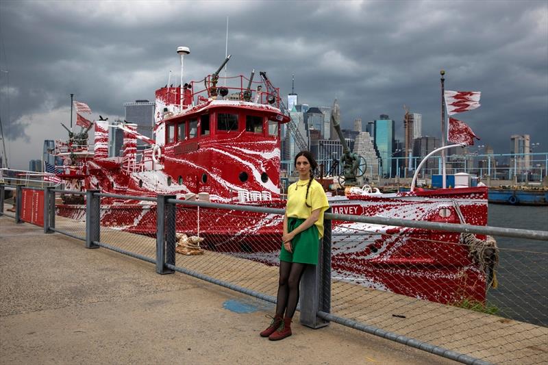 Tauba Auerbach, an artist, at Brooklyn Bridge Park in front of the John J. Harvey, a former Fire Department boat that she painted in a style meant to mimic dazzle painting, a form used during World War I to try to shield Allied boats from German U-boats photo copyright Hiroko Masuike / The New York Times taken at  and featuring the Power boat class