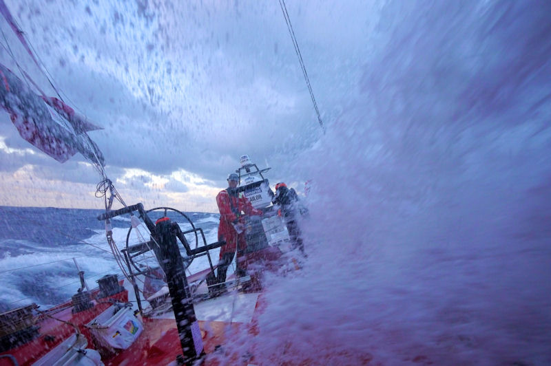 Andrew McLean on the aft grinding pedestal just about to get hosed by water onboard CAMPER during leg 7 of the Volvo Ocean Race photo copyright Hamish Hooper / CAMPER ETNZ / Volvo Ocean Race taken at  and featuring the Volvo 70 class