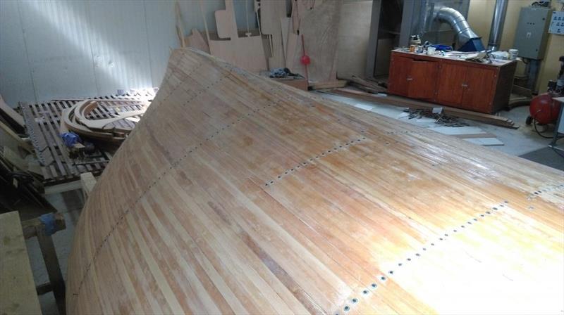 Croatian Gajeta build - The first rows of screws are in the process of being removed and the hull sanded to abrade back any squeezed-out epoxy - photo © West System International