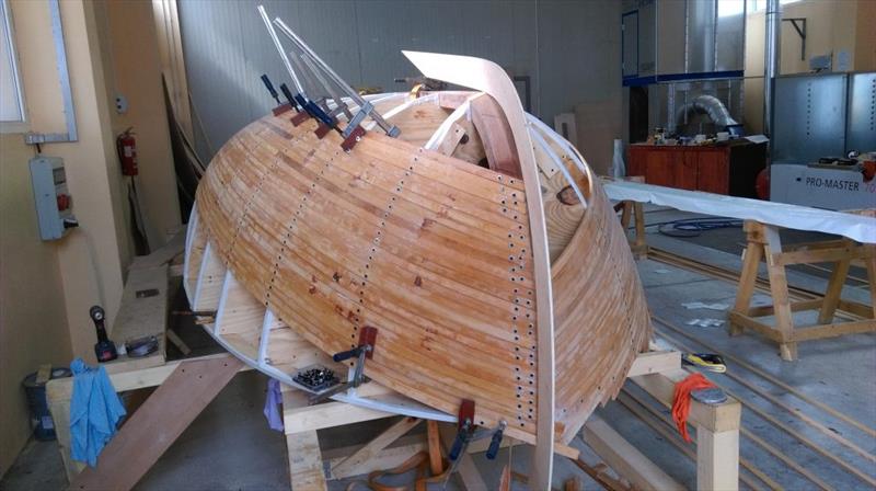 Croatian Gajeta build - As the planking advances, a template of the CNC outer keel is offered up to ensure the shape is correct - photo © West System International